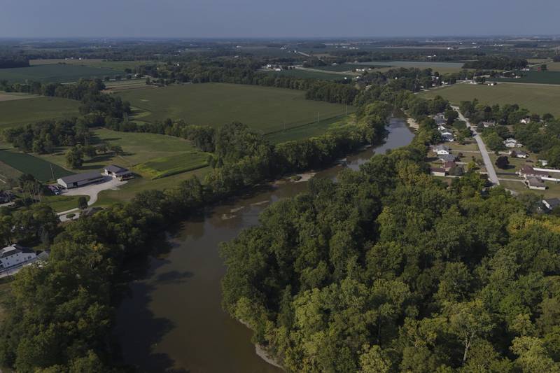 Water flows down the Sandusky River between farms in Fremont, Ohio.