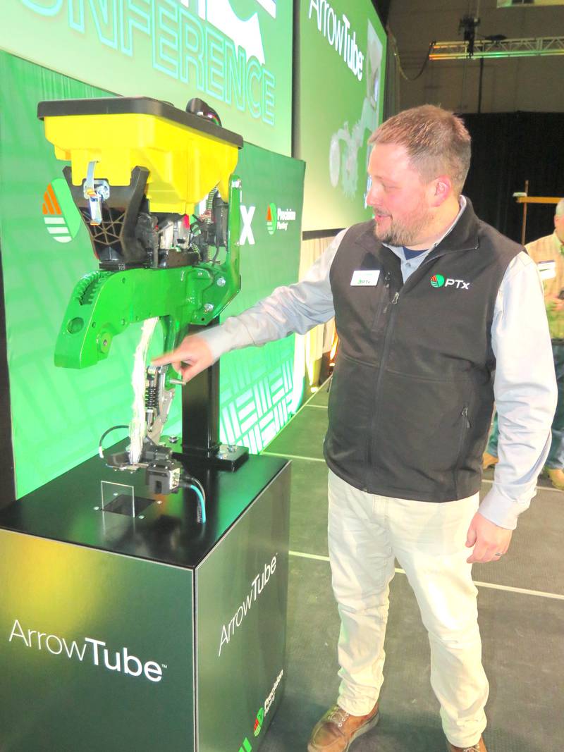Ryan Baker, PTx mechanical engineer, points out the new ArrowTube seed delivery system places the corn seed tip down to promote even germination and emergence.