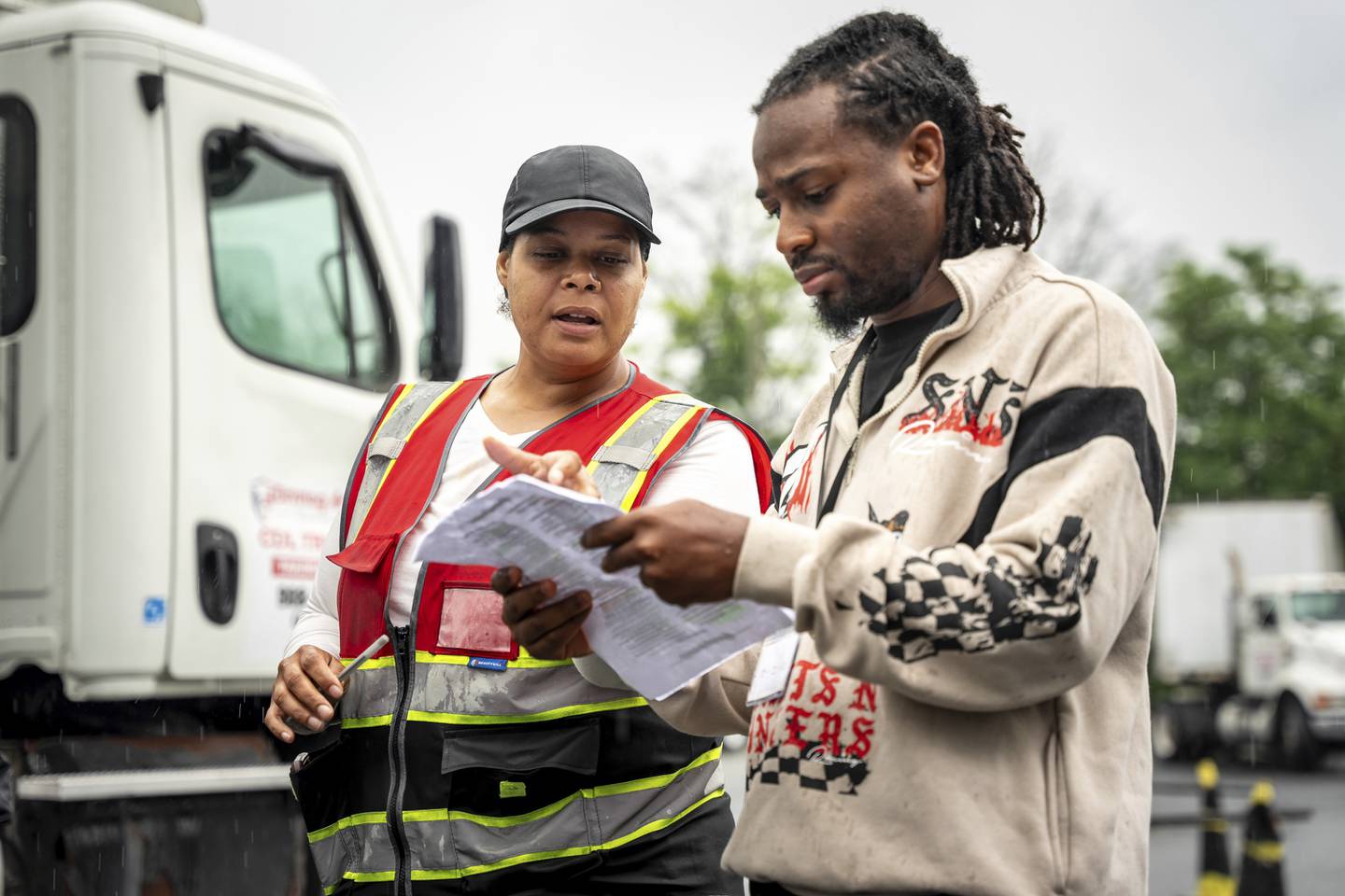 An instructor helps a student study at the Driving Academy in Linden, New Jersey, where students prepare to obtain a commercial driver’s license with multilingual instructors.