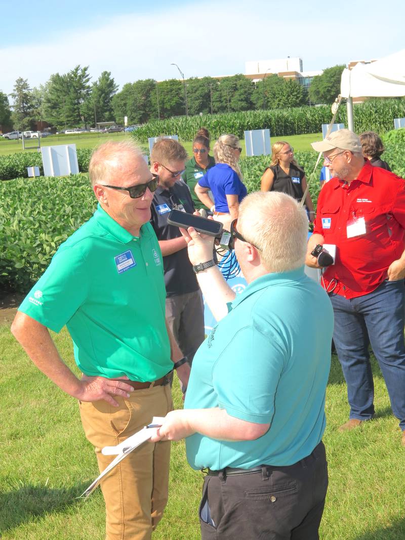 Brad Van Kooten (left), Pioneer Seeds marketing leader for seed applied technologies, meets with members of the media after Corteva announced its launch of Lumidapt Valta LS, a new nutritional naturally-derived seed treatment. The company hopes regulatory approval will take place this fall.