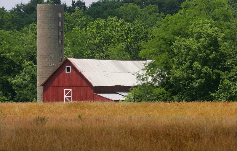 A farm field and barn are bathed in sunlight after a rain shower near Springfield, Illinois.