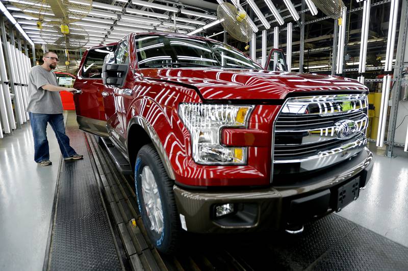 A worker inspects a new aluminum-alloy body Ford F-150 truck at the company's Kansas City Assembly Plant in Claycomo, Missouri.