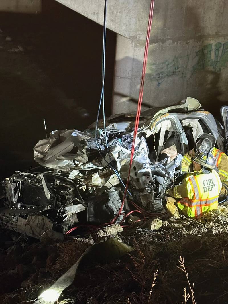 Police rescue a man after finding his damaged vehicle on Dec. 26 along Interstate 94 near Portage, Indiana. Police say the man who was rescued after being trapped for six days in his crashed pickup truck drank rainwater to survive the ordeal while pinned in the wreckage beneath the Indiana highway bridge.