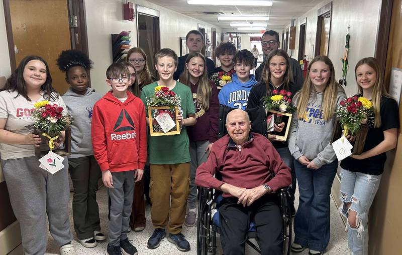 For one of their activities, members of the Cambridge Middle FFA Chapter presented flower arrangements to residents at a nursing home, including retired ag teacher Floyd Worley. The students built the flower vases in the wood shop and arranged the flowers with skills they learned in their floral design class.