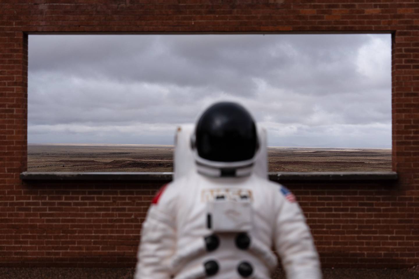 An astronaut figure is placed in front of a window opening at Meteor Crater, an attraction near historic Route 66, near Winslow, Arizona.