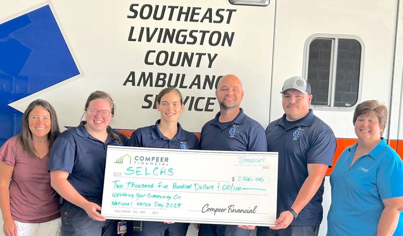 Volunteers with Southeast Livingston County Ambulance Service accept $2,500 from Diane Harfst, lending officer with Compeer Home, to recognize their selfless service in honor of National Heroes Day. Amy Ifft nominated SELCAS. Participating in the presentation are Ifft (from left), Kendra Edelman, Loretta Grimm, Justin Koehl, Gavin Cox and Harfst.