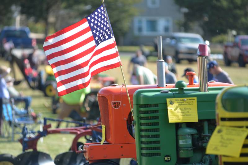 An American flag flies on one of the antique tractors at the Autumn on Parade Tractor Classic on Saturday, Oct. 5, 2024, held during Autumn on Parade in Oregon. The Saturday event was held at Oregon Park East.