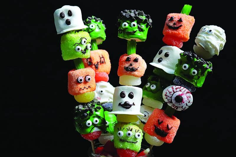 Marshmallows coated in sugar or candy melts and decorated to look like monsters make a fun Halloween treat, especially when skewered on a stick.