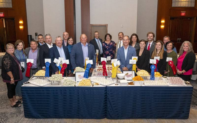 Prairie Farms Dairy representatives gather around the winning entries in the National Milk Producers Federation Dairy Product Judging Contest, including Karen Schroeder (from left) , Emily McClelland, Pat Schroeder, Luke Haywood, Gregg Doud, Randy Mooney, Craig Meng, Kristin Meng, Frank Doll, Toby Probst, Margie Probst, Robert Horst, Matt McClelland, Sam Schwoeppe, Hannah Lansing, Matt Lansing, Nicole Engelken, Jason Roberts, Heather Roberts and Ashley Davis.