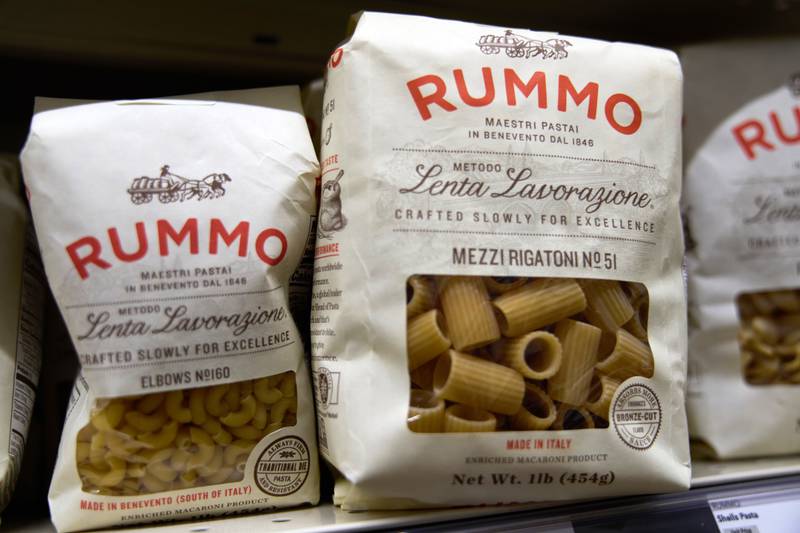 Packages of imported Italian pasta sit on shelves.