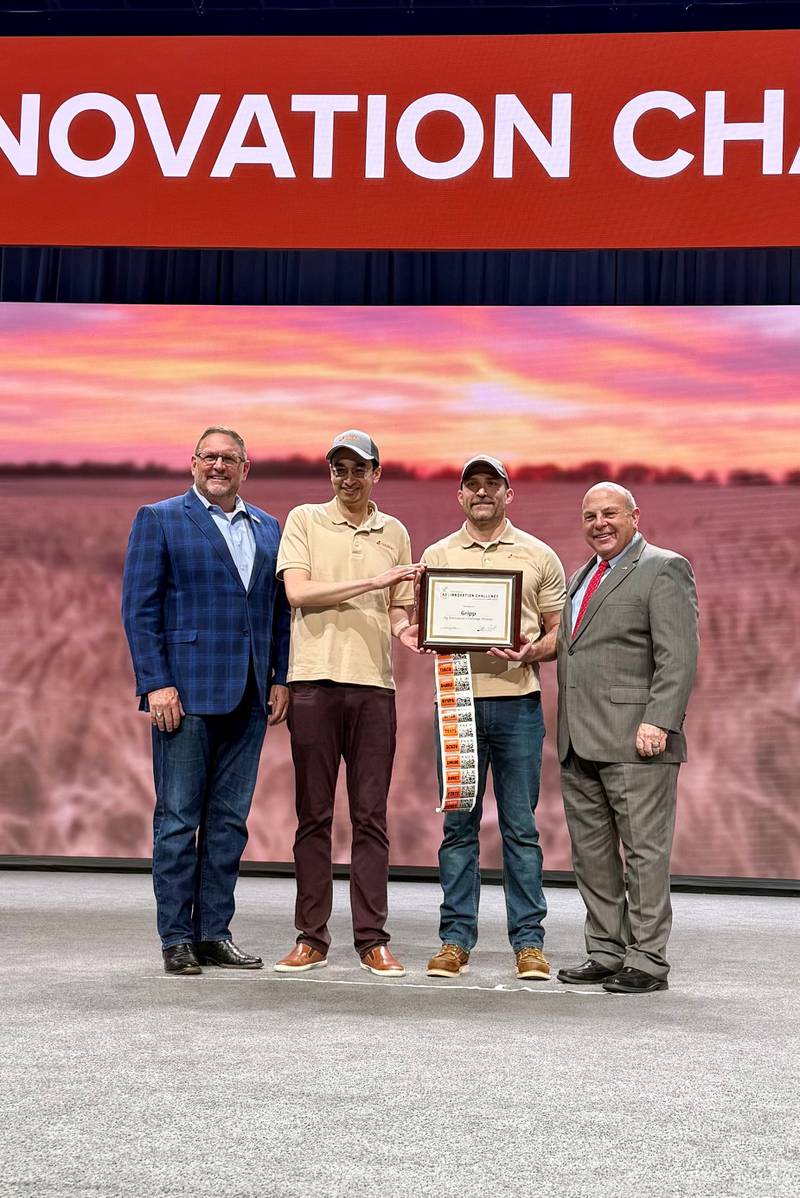 Tracey Wiedmeyer (second from right), CEO and co-founder of Gripp, and Jenkin Lee (second from left), co-founder and chief product officer, accept the award for the Ag Innovation Challenge presented by the American Farm Bureau Federation and Farm Credit.