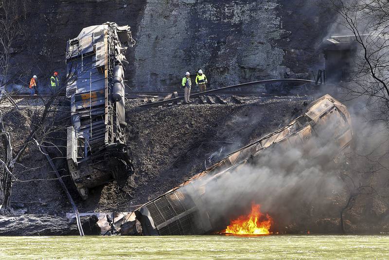 Smoke fills the sky after an empty CSX coal train hit a rockslide along tracks causing a fiery derailment in March 2023 in a remote area just south of Sandstone, West Virginia.