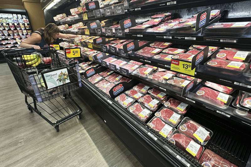 A shopper compares beef prices at a grocery store in Mount Prospect in northeast Illinois.
