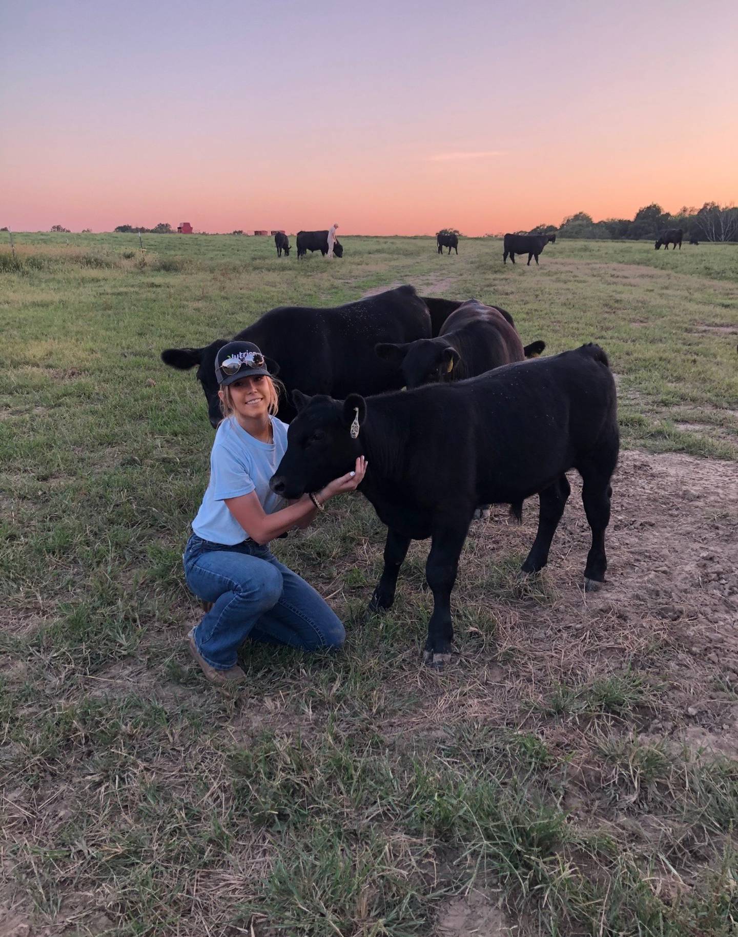 Shelby Pribble checks on some of her Angus herd that totals 55 animals. Her responsibilities include administering vaccinations and she focuses on keeping accurate records of birth and market dates.