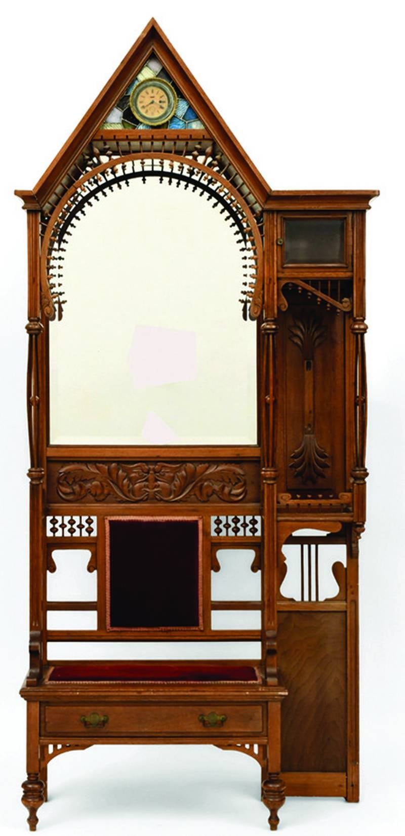 Hall trees were both decorative and functional. This one from about 1900 features an upholstered seat, stained glass and a clock, as well as the typical umbrella stand, bench and mirror.