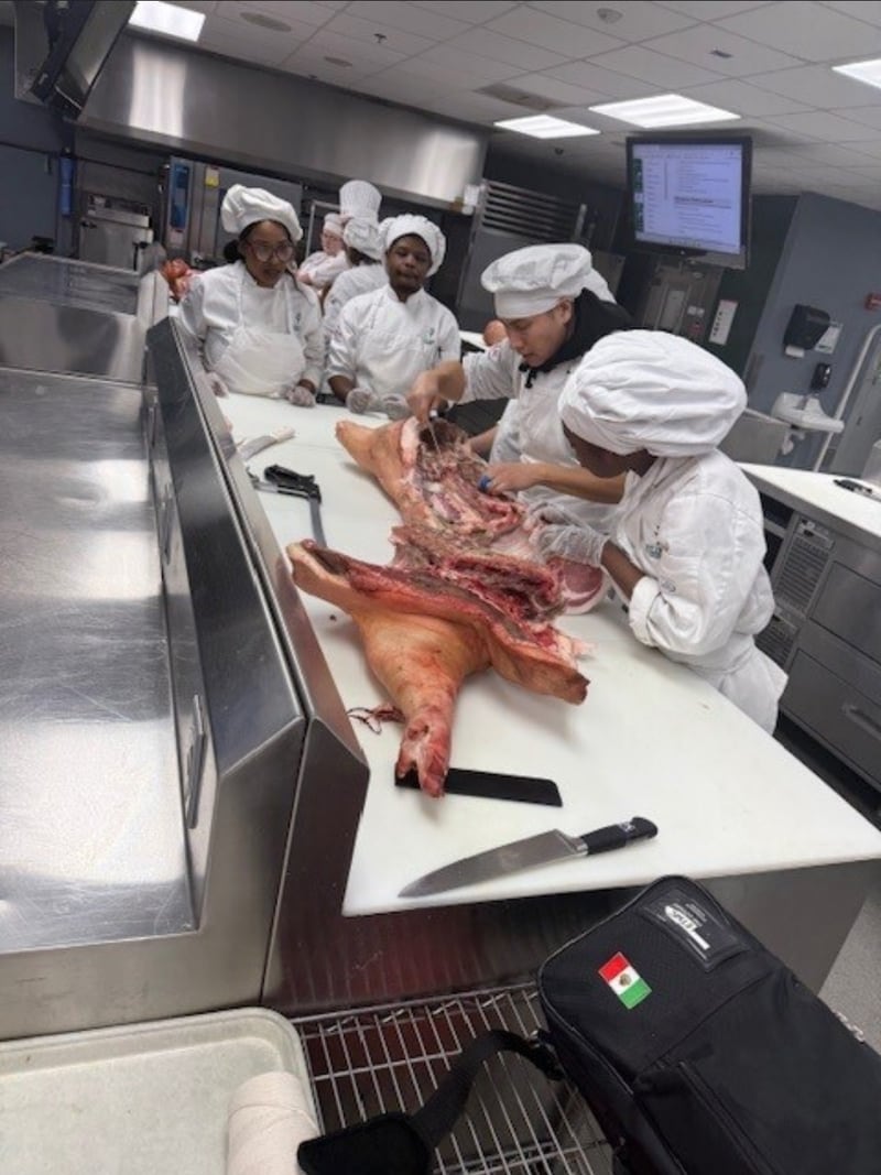 Ivy Tech Culinary students fabricate a market-weight pig. Students then used the cuts of pork in a variety of preparations in the classroom and in their student-run restaurant.