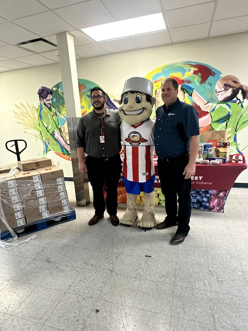 Indiana Pork farmer Mark Johnson (far right) is joined by Adam Robey with Community Harvest Food Bank and Johnny TinCap, the mascot of the Fort Wayne TinCaps, to make a ground pork donation to the Fort Wayne Community Food Bank.