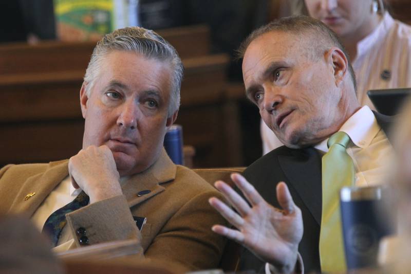 Kansas state Reps. Gary White (left), R-Ashland, and Shannon Francis, R-Liberal, confer as the House votes on legislation at the Statehouse in Topeka. The two lawmakers support a measure approved by the House to limit ownership of land by people and companies from China and other U.S. adversaries.