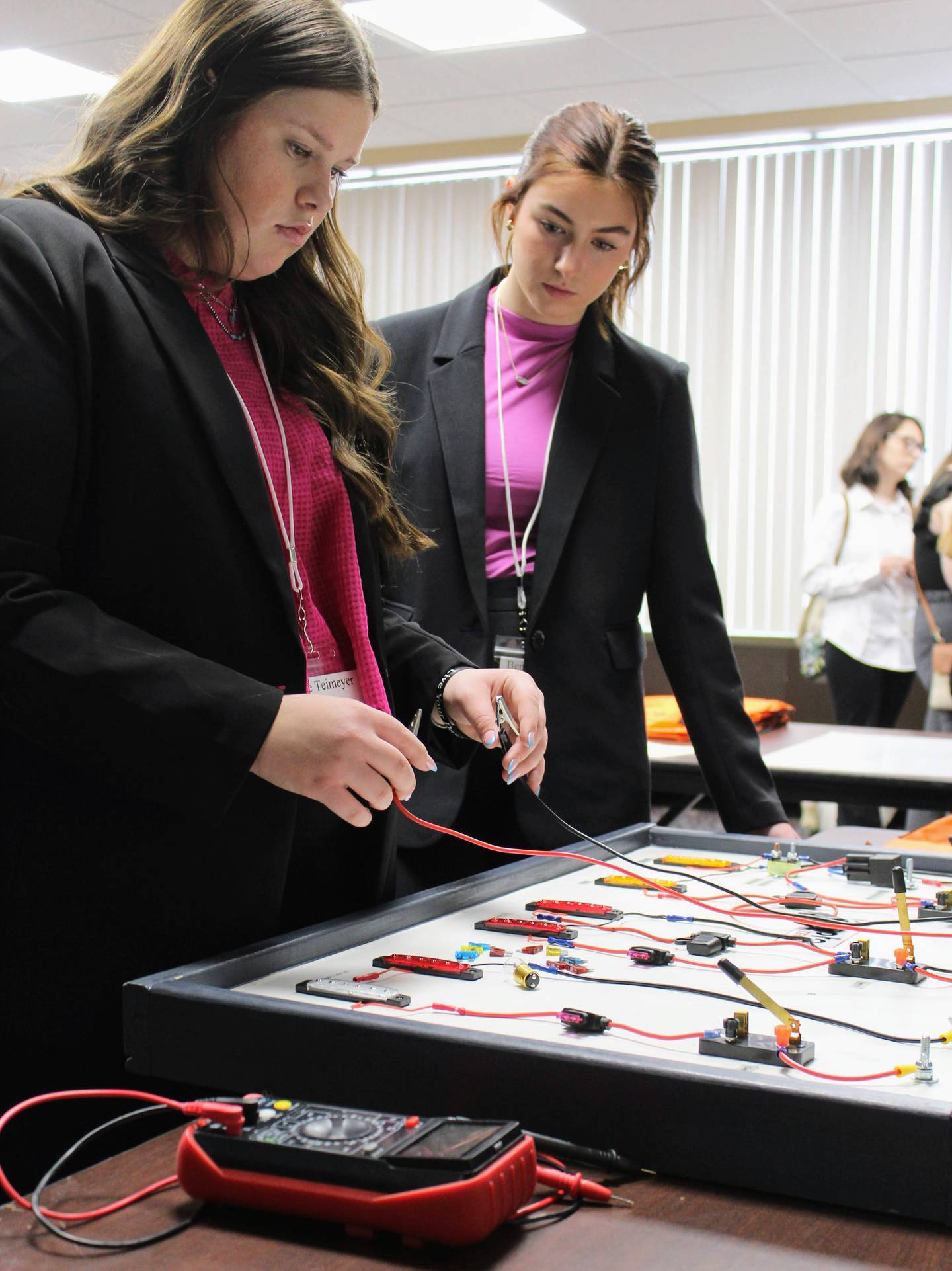 During the Kubota session, students learn about a variety of electrical circuits, as well as how to test if fuses are good or bad, at the Women Changing the Face of Agriculture event.