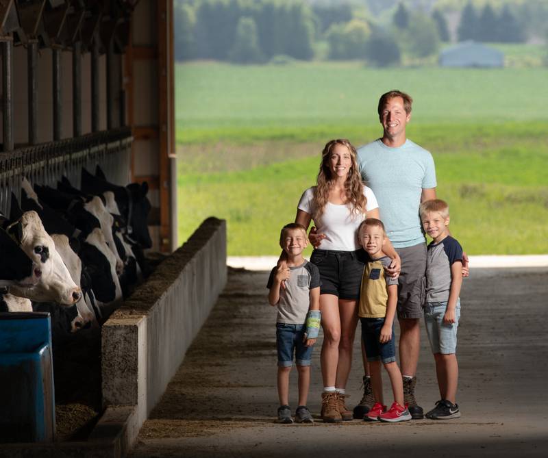 Kyle and Rachel Zwieg with their children, Landon (from left), Logan and Theodore, at their seventh-generation dairy and crop farm.