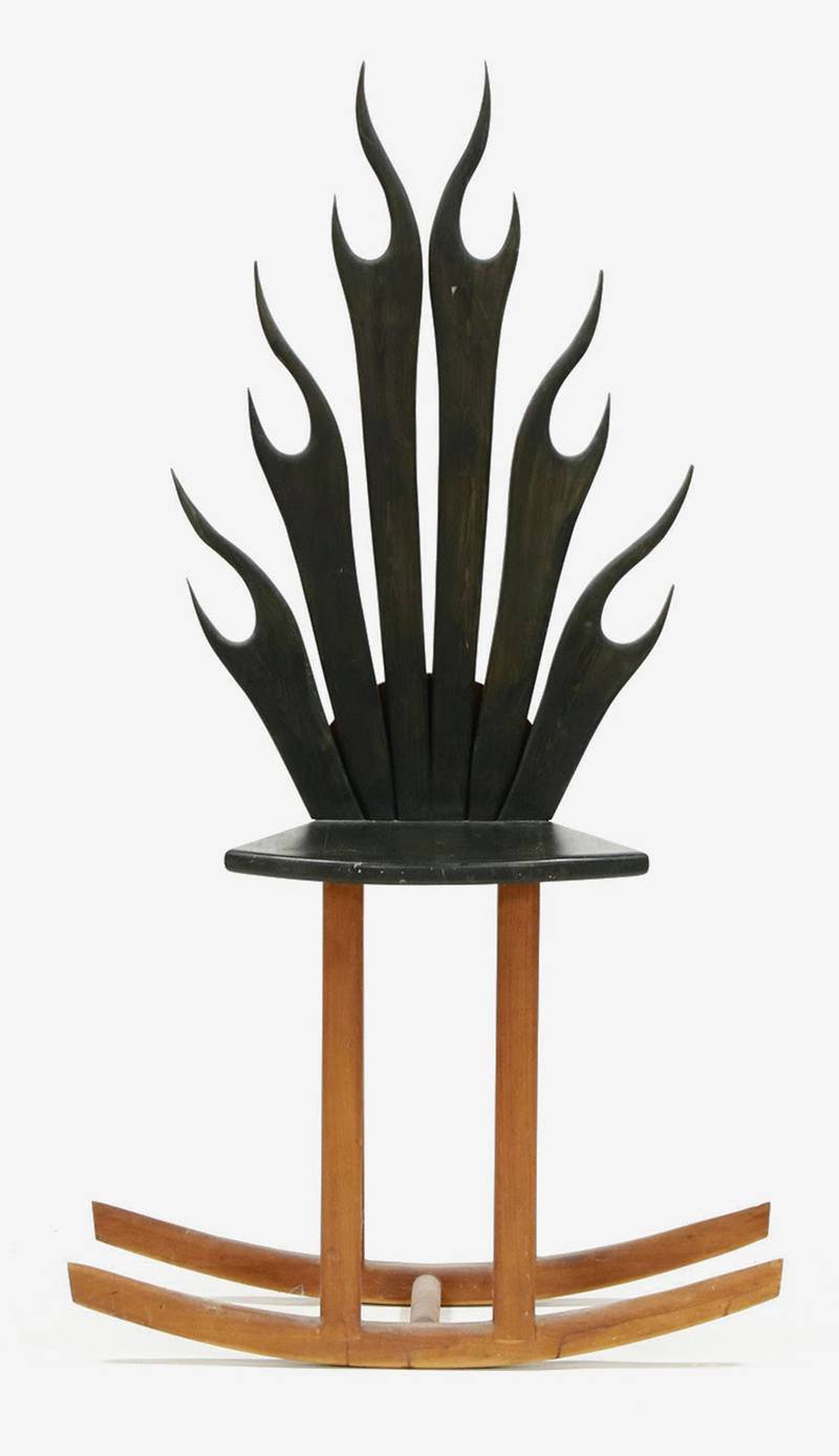 Stylized shapes, light wood, bold blocks of color and unusual construction are characteristics of modern furniture. This flame rocking chair shows all four.