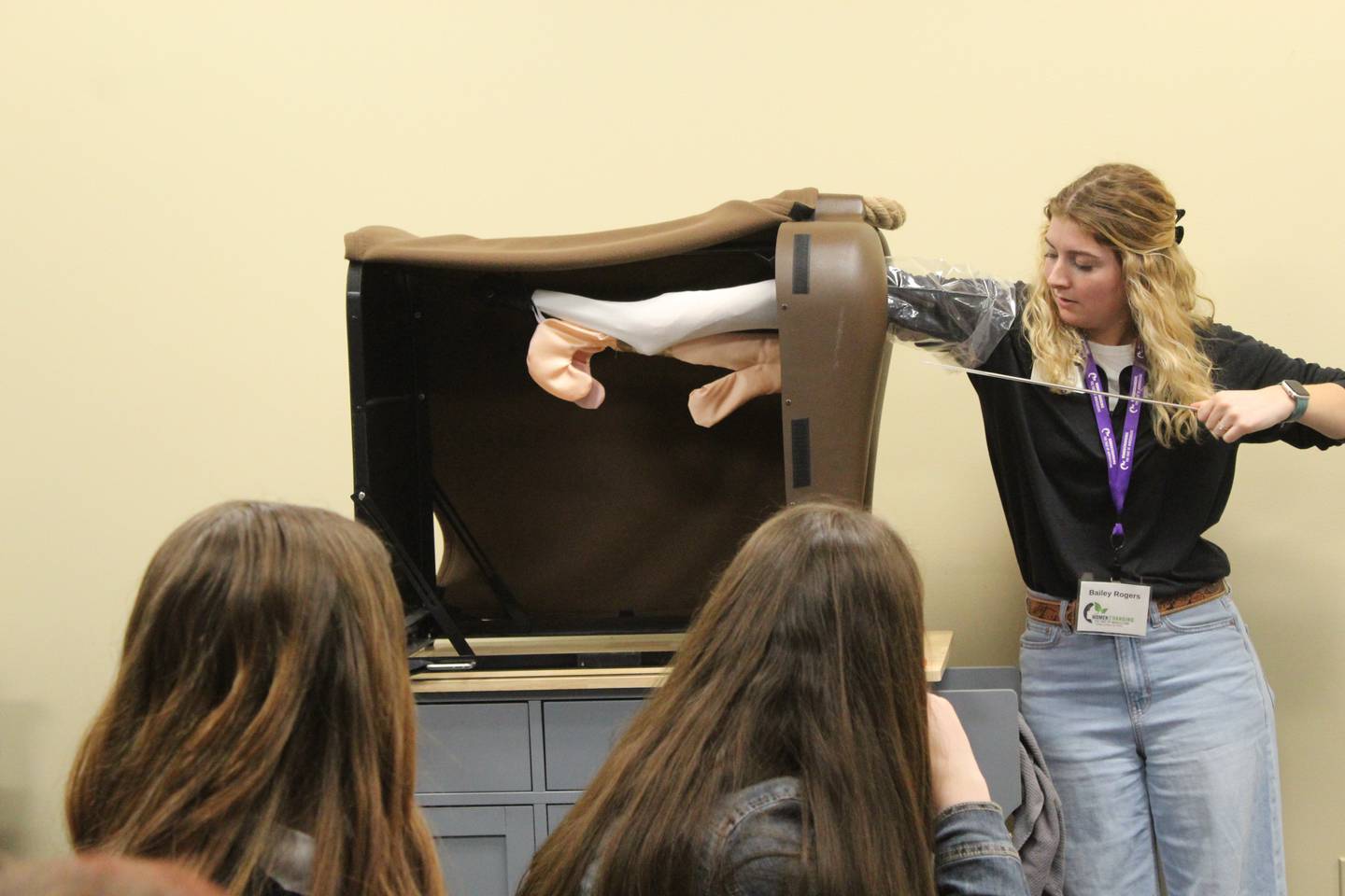 Bailey Rogers demonstrates how to artificially inseminate a beef cow using a simulator during a skills session at the Women Changing the Face of Agriculture event at Heartland Community College. Women are valued as AI technicians because they typically have smaller hands than men.