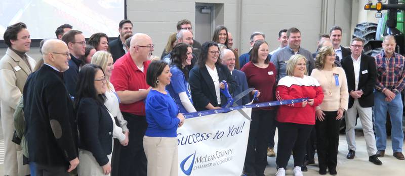 AGRINEWS PHOTO/TOM C. DORAN
A ribbon-cutting marked the opening of Heartland Community College's Agriculture Complex. The $23 million facility includes instructional and community education space. Becky Ropp, HCC Board of Trustees chair, had the honors of cutting the ribbon. HCC President Keith Cornille is to the right of Ropp.