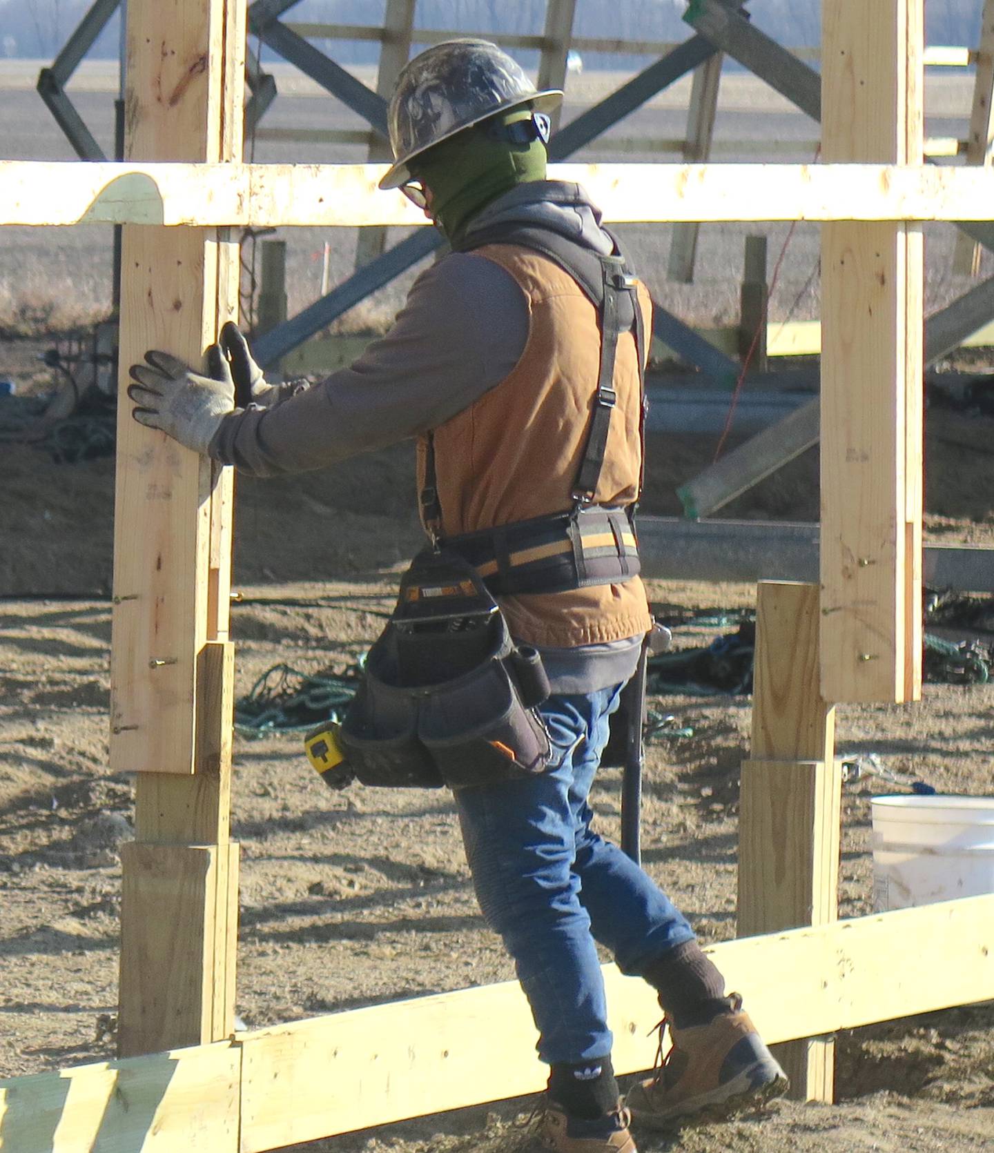 An FBi Buildings worker adjusts the wall beams to the bottom base once the roof was raised. The wall beams were then secured to the base.