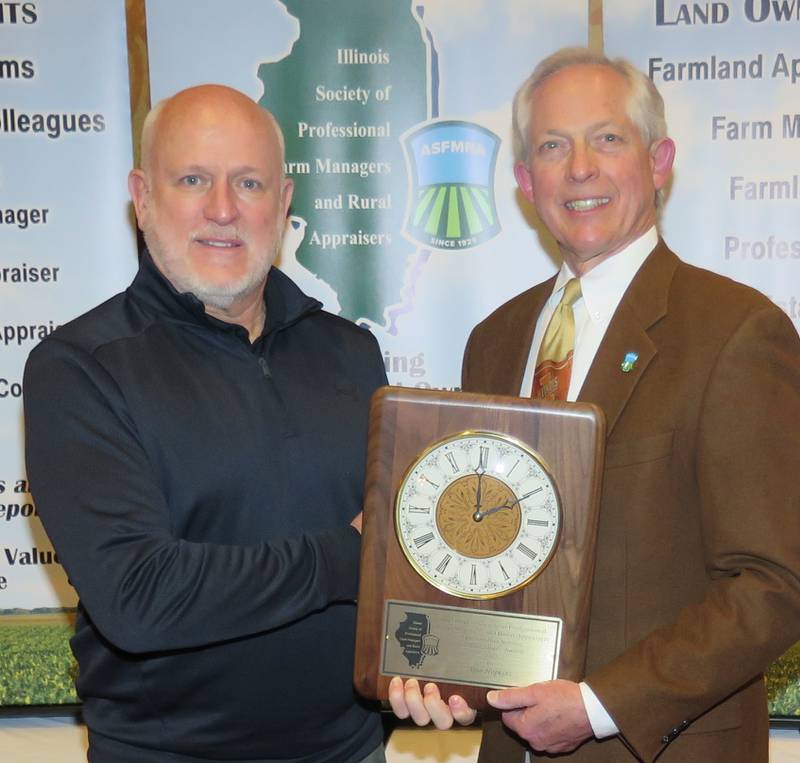 Alan Hopkins (left) was recognized for his decades of dedication to the agricultural industry with the ISPFMRA top honor for a non-manager/appraiser, the Service to Agriculture Award. The award was presented by Russ Hiatt, ISPFMRA immediate-past president.