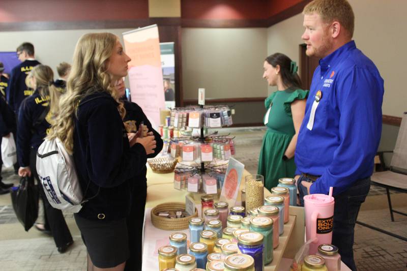 Darren and Kendall Riskedal talk with FFA students in the Career Show during the Illinois FFA State Convention at their booth for Country Lights candles. About 90% of the Country Lights products are sold through fundraisers conducted by FFA chapters, 4-H clubs, church youth groups or cheerleading squads.