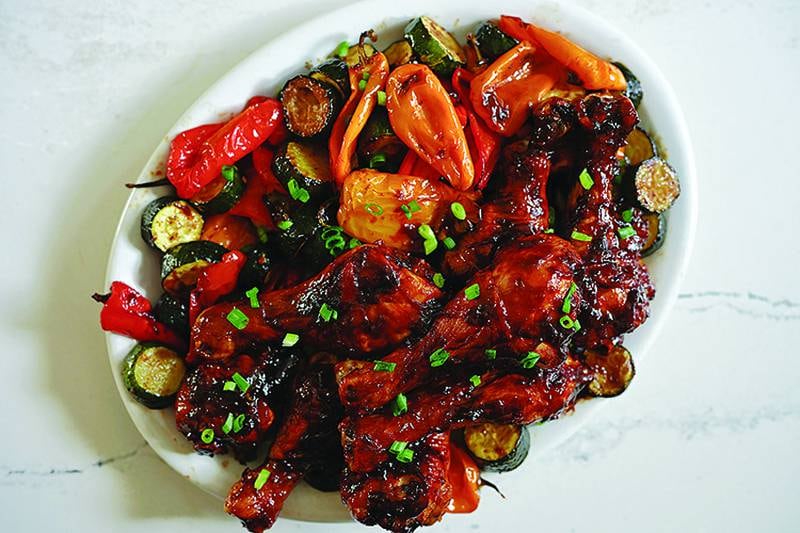 Sticky orange balsamic glaze transforms simple drumsticks and vegetables.