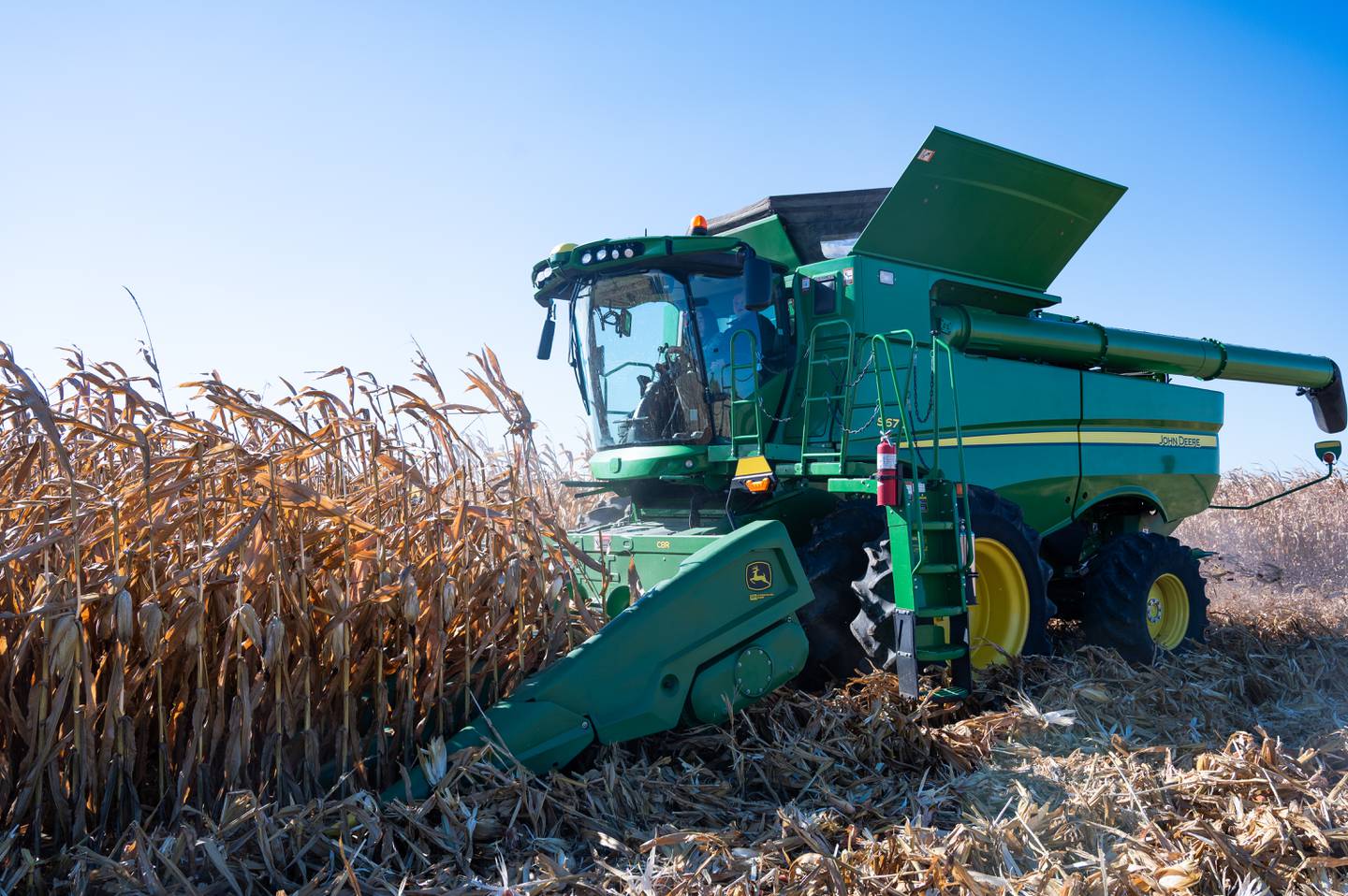 U.S. Secretary of Agriculture Brooke Rollins harvests a few rows of corn with Tyler Everett.