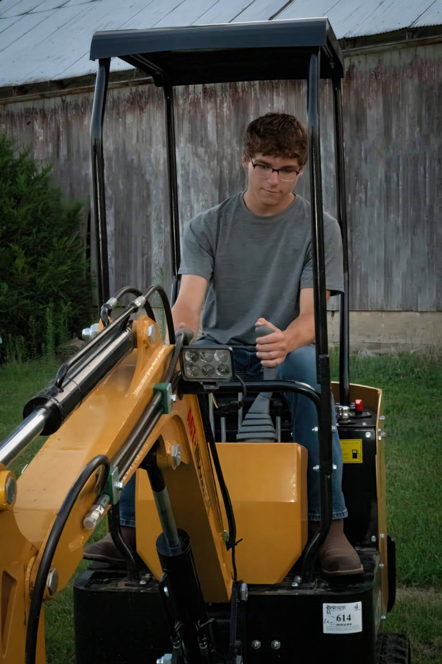 Seth Mund operates one of his machines that he uses for his FFA project that includes a lawn care and landscape company.