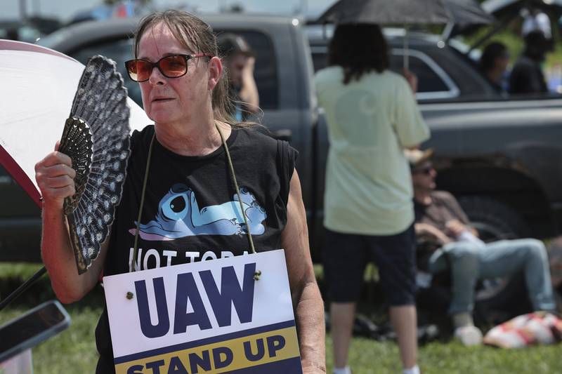 Assembly line worker Sheila Buckley tries to keep cool while on the picket line as members of United Auto Workers Local 282 are on strike against Lear, a car and truck seat manufacturer in Wentzville, Missouri. The strike led to a shutdown at the nearby GM assembly plant.