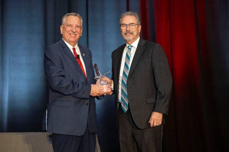 Mark Gebhards (right), of Springfield, accepts the 2025 Illinois Farm Bureau Eagle Award for Excellence from IFB President Brian Duncan during the organization’s Annual Meeting in Chicago.