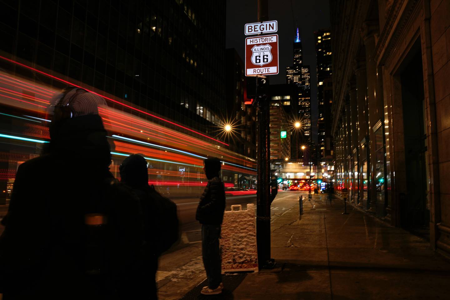 A sign marking the beginning of historic Route 66 stands at the intersection of East Adams Street and South Michigan Avenue in Chicago.