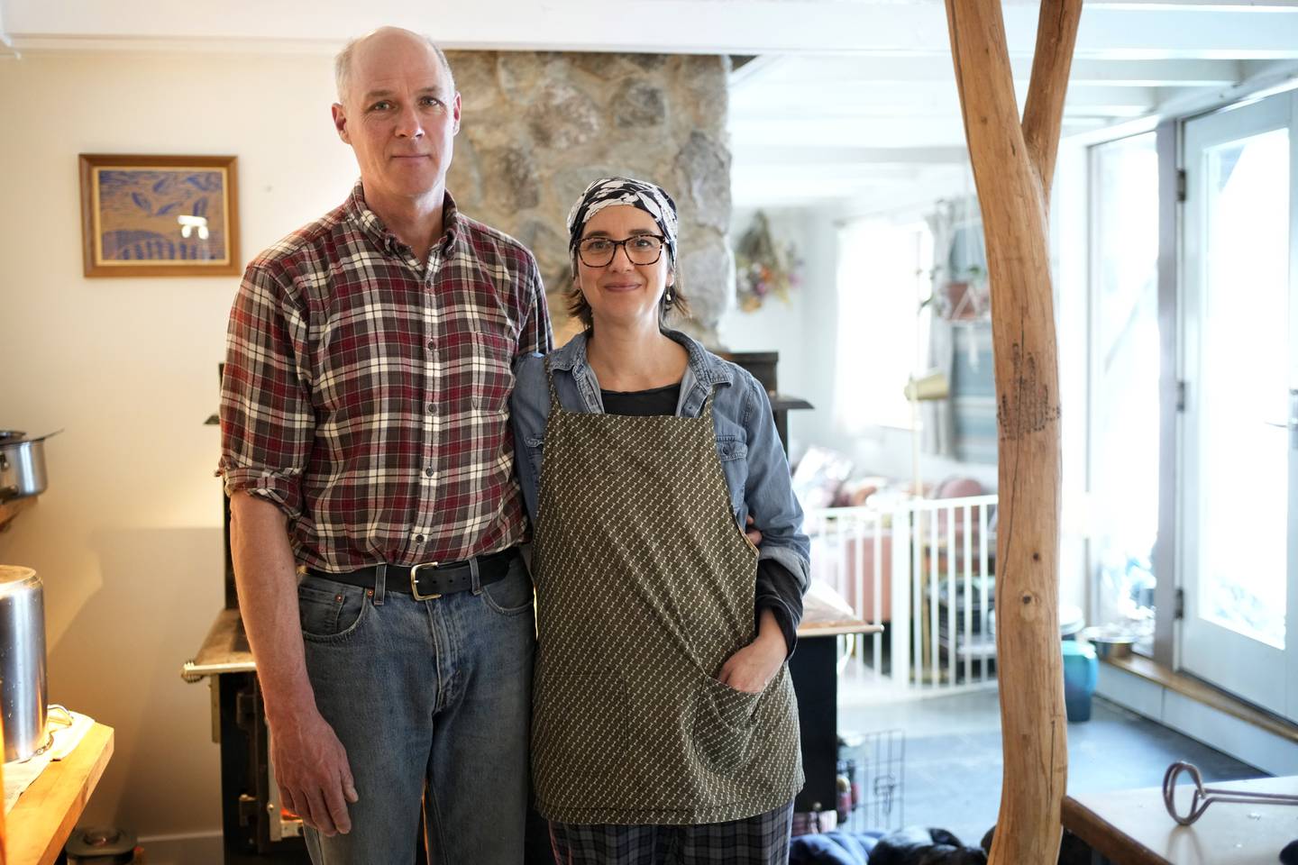Organic wild blueberry farmers Hugh and Jenny Lassen pose in their home in Cherryfield, Maine.