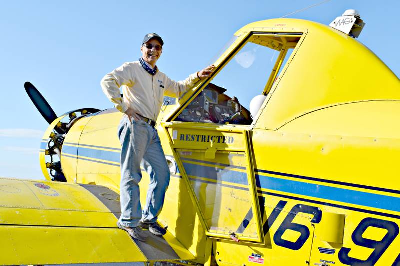 Robert Sneberger, owner of Aerial Farmer LLC, stands next to his Air Tractor 301. Before becoming an agricultural pilot, he worked as an engineer in Montana. Crop dusters fly specially equipped aircraft low over fields or forests to spray crops and trees with chemicals such as pesticides and herbicides designed to destroy pests or control weeds.