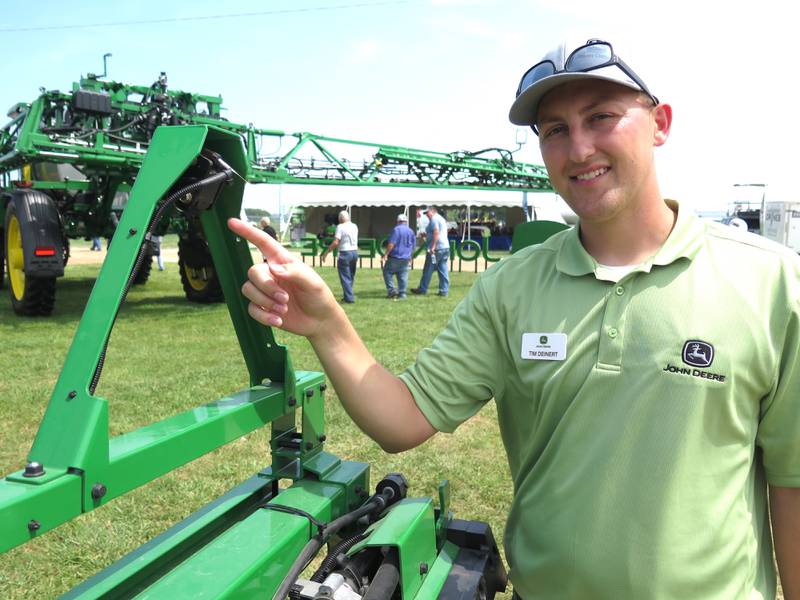 Tim Deinert, John Deere marketing manager, points out one of the boom cameras used for identifying weeds versus crops in the See and Spray system. The See and Spray Premium upgrade kit for sprayers was featured at the recent Midwest Ag Industries Expo in Bloomington, Illinois.