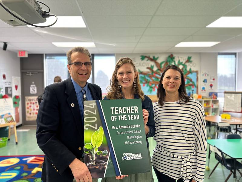 Amanda Stanko (center) of Corpus Christi Catholic School was named Illinois Agriculture in the Classroom Teacher of the Year. Participating in the presentation were Kevin Daugherty, director of Agricultural Engagement, and Carrie Vogel, McLean County AITC coordinator.