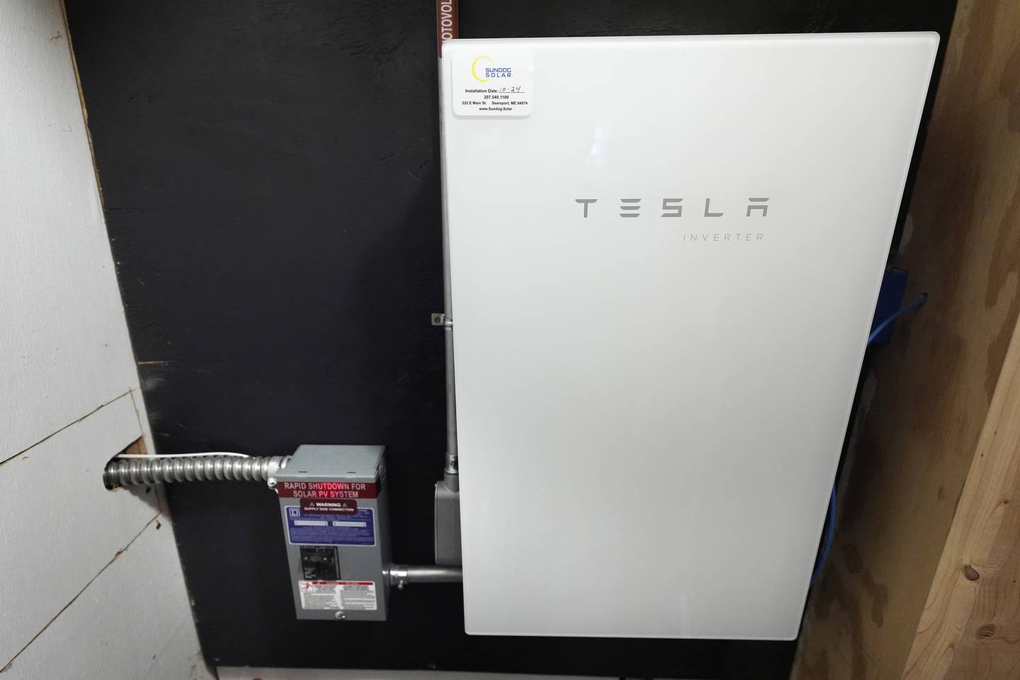 A Tesla power inverter is used in gathering electricity from an array of solar panels at Intervale Farm in Cherryfield, Maine.