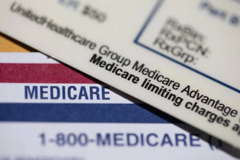 A UnitedHealthcare Group Medicare Advantage PPO card rests on top of a Medicare card.