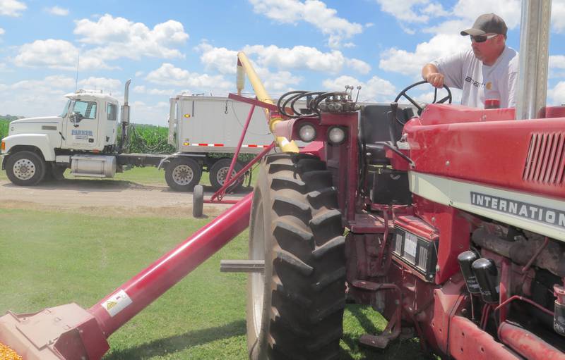 Dan Parker, of Dwight, spent a good portion of July 1 hauling corn from the family’s Grundy County farm in northeast Illinois to ADM’s river facility at nearby Morris. Here he’s filling the truck for the second trip to the elevator about mid-day.