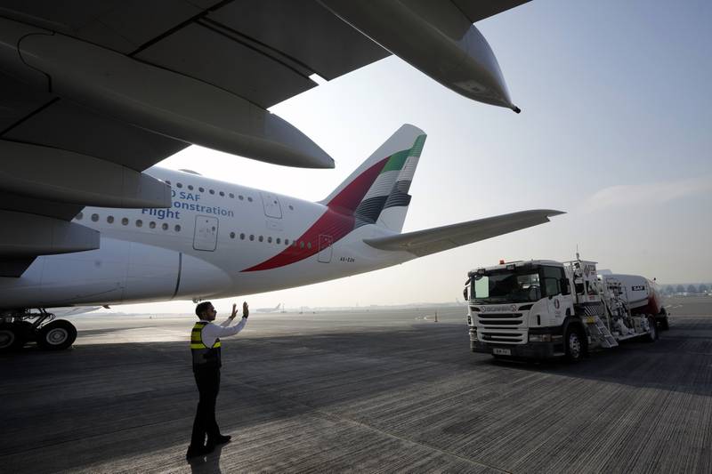 A truck carrying sustainable aviation fuel, or SAF, approaches an Emirates A380 demonstration flight during a media tour at the Dubai airport in United Arab Emirates.