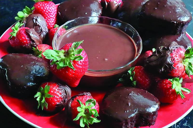 Ganache in the middle, chocolate-dipped cupcakes and strawberries circling like devoted valentines.