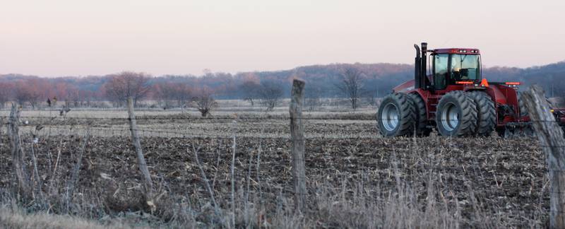 A tractor tills soil on farmland just outside the eastern entrance to Starved Rock State Park near Ottawa in north-central Illinois.