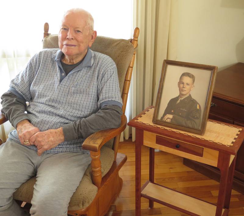 Mike Sager, 97, of Eureka, Ill., was born in a log home in southern Illinois and went on to a long career as Woodford County agricultural adviser. The photo, sitting on a table he built, is of Sager when he was 18 years old and entered the Army during World War II.