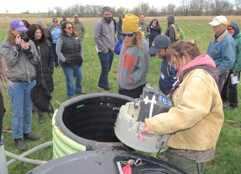 Maria Lemke, The Nature Conservancy’s Illinois director of conservation science, shows the inner-workings of an automatic water sample collection system. Samplers measures the amount of nitrogen and phosphorous entering and exiting at each wetland on the Franklin Research and Demonstration Farm.