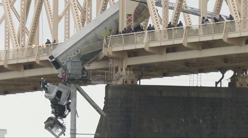 Emergency crews rescue the driver of semitruck that is dangling off the Clark Memorial Bridge over the Ohio River on March 1 in Louisville, Kentucky. The driver was pulled to safety by firefighters following the three-vehicle crash on the bridge connecting Kentucky to southern Indiana.