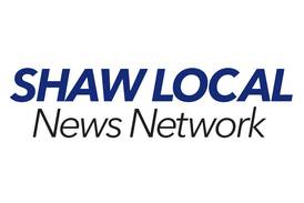 Two injured in a crash involving grain spreader and pickup truck